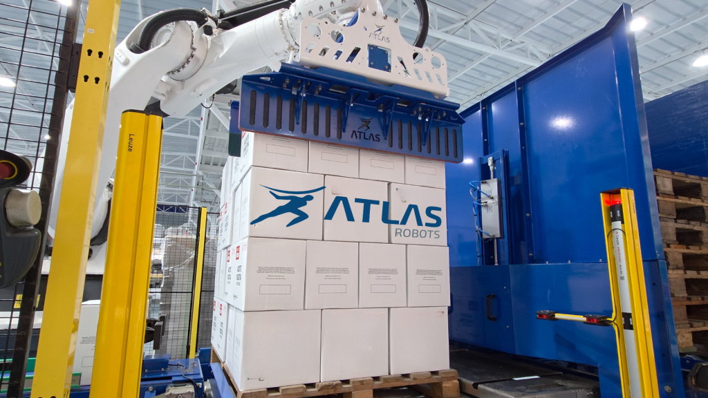 Efector final (Gripper) manipulando cajas para paletizado automatizado.